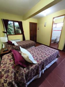 a hotel room with two beds and a window at Hostal el Arroyito in Ushuaia