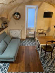 a living room with a couch and a table at Dimora Noblac in Monopoli