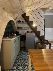 a kitchen with a staircase and a refrigerator at Dimora Noblac in Monopoli