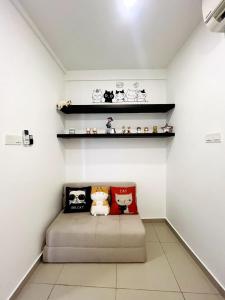a room with a couch with stuffed animals on shelves at Neko Homes at i-City - WiFi TV Box 1 Carpark in Shah Alam