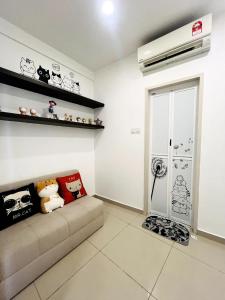 a living room with a couch in a room at Neko Homes at i-City - WiFi TV Box 1 Carpark in Shah Alam +18 photos