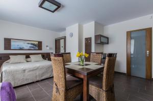 a bedroom with a table and chairs and a bed at Villa Nova 34A in Hel
