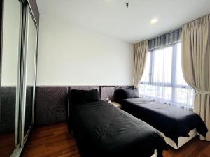 a bedroom with two beds and a window at Novel Homes at i-City - WiFi TV Box 1 Carpark in Shah Alam