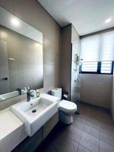 a bathroom with a sink and a toilet and a mirror at Novel Homes at i-City - WiFi TV Box 1 Carpark in Shah Alam