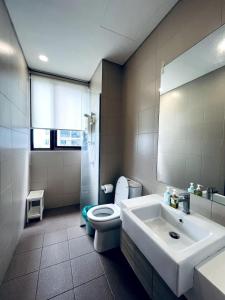 a bathroom with a white toilet and a sink at Novel Homes at i-City - WiFi TV Box 1 Carpark in Shah Alam
