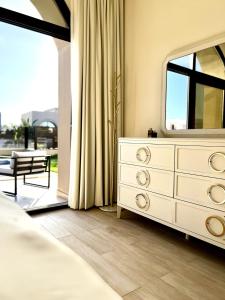 a bedroom with a dresser and a mirror at WeTake Hawana in Salalah