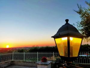 a street light with the sunset in the background at Vittò in Martina Franca
