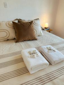 a bed with two towels sitting on top of it at Terranova in Federación +48 photos