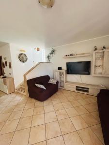 a living room with a couch and a flat screen tv at Villa Teresa in Ginosa Marina