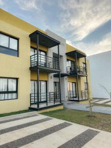 a yellow building with balconies on the side of it at Terranova in Federación