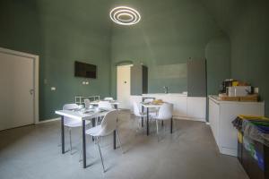 a kitchen with white tables and white chairs in a room at Maison Le Blanc Luxury B&B in Giovinazzo +32 photos