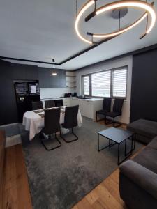 a kitchen and living room with a table and chairs at 3 Zimmer Wohnung in Maria Lanzendorf