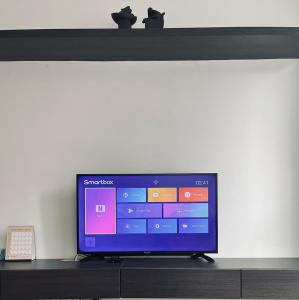 a flat screen tv sitting on top of a shelf at Onyx Homes at i-City - WiFi TV Box and 1 Car Park in Shah Alam