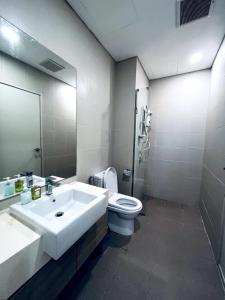 a bathroom with a sink and a toilet and a mirror at Onyx Homes at i-City - WiFi TV Box and 1 Car Park in Shah Alam +10 photos