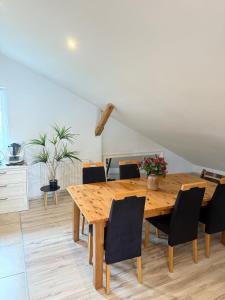 a dining room with a wooden table and chairs at 120m2 APARTAMENT LAS I JEZIORO in Człuchów +7 photos
