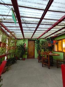 a patio with a table and some potted plants at Hostal el Arroyito in Ushuaia