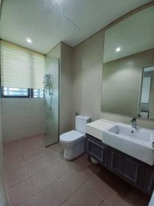 a bathroom with a sink and a toilet and a mirror at Phenom Homes at i-City - WiFi TV Box 1 Carpark in Shah Alam