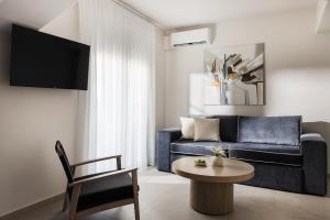 a living room with a blue couch and a table at Meteoron Suites in Kalabaka