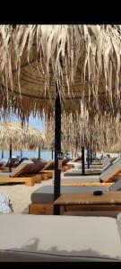 a group of chairs and umbrellas on a beach at Villa Eleonas in Mákri