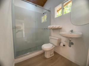 a bathroom with a shower and a toilet and a sink at ANIMATERRA Luxury Lodge SISGA in Chocontá +34 photos
