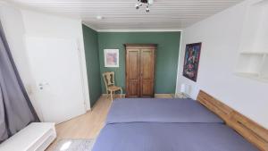 a bedroom with a bed and a chair in it at Urlauber und Monteure willkommen in Baesweiler