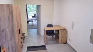 a room with a wooden desk and a table at Urlauber und Monteure willkommen in Baesweiler
