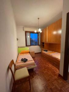 a small room with a bed and a bench in it at Casa Vacanza Anna in Verbania