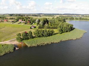 an island in the middle of a body of water at Domek nad jeziorem Weekend in Swiętajno