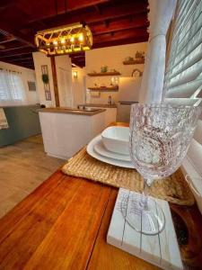 a wine glass sitting on top of a wooden table at La Casita Blanca Chalet Incredible View Romantic in San Lorenzo