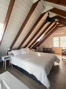 a bedroom with a large bed in an attic at La Casita Blanca Chalet Incredible View Romantic in San Lorenzo