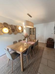 a dining room with a wooden table and chairs at Le cottage du renard, à côté de la Meuse Namur et Dinant in Namur +8 photos
