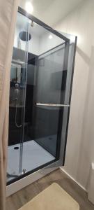 a shower with a glass door in a bathroom at Notre Doux Logis in Les Bordes +56 photos