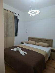 a stuffed animal laying on top of a bed at Vhtwins apartment in Ulcinj