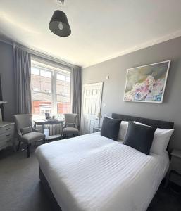 a bedroom with a large bed and a living room at Providence in Seaford in Seaford