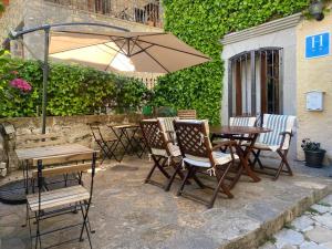 a patio with a table and chairs and an umbrella at Hotel Casa Socotor in Sallent de Gállego