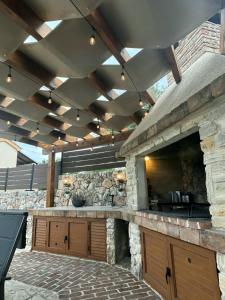 an outdoor kitchen with a stone wall at Villa LuLu kamena villa s maslinikom otok Krk Dobrinj selo Gostinjac in Krk +47 photos