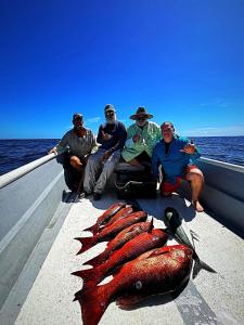 a group of people sitting on a boat with a fish at Casa Piscina - House with a pool in David in David