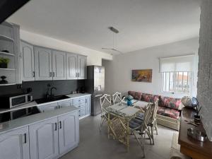 a kitchen and living room with a table and a couch at VillaKaliba BEACHFRONT HOUSE in Kalives Poligirou +15 photos