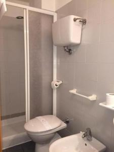 a bathroom with a toilet and a shower and a sink at Hotel Florida in Montecatini Terme