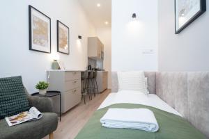 a small bedroom with a bed and a chair at Studio Apartment by Hi5-Charming Studio in Budapest