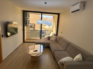 a living room with a couch and a table at Belle cote appartement al hoceima in Al Hoceïma