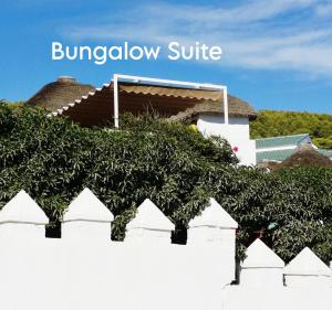 a bunch of green plants on a white wall at Mandala Bungalows - Adults Only in Los Caños de Meca