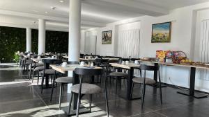 a restaurant with tables and stools in a room at MAISON de VACANCES Bouillon 30 personnes in Bouillon