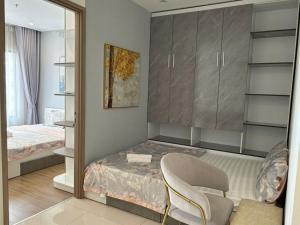 a small bedroom with a bed and a mirror at VINHOMES GRAND PARK QUẬN 9 Căn hộ bnb 1pn in Gò Công +99 photos