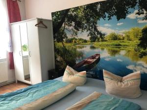 a room with a painting of a river and a boat at Ferienwohnung Zur Weißen Taube in Dobbertin