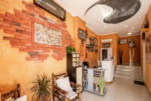 a living room with a brick wall at Family Hotel Paros in Pomorie