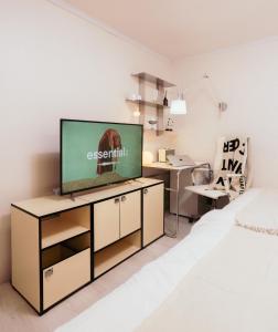 a living room with a television on a cabinet at 반포레스트 room3 in Seoul