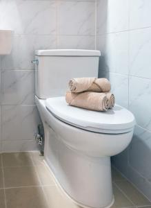 a white toilet in a bathroom with towels on it at 반포레스트 room3 in Seoul