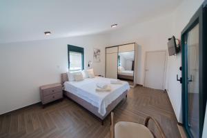 a bedroom with a large bed and a mirror at Villa Goranovic in Herceg-Novi