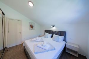 a bedroom with a bed with two towels on it at Villa Goranovic in Herceg-Novi